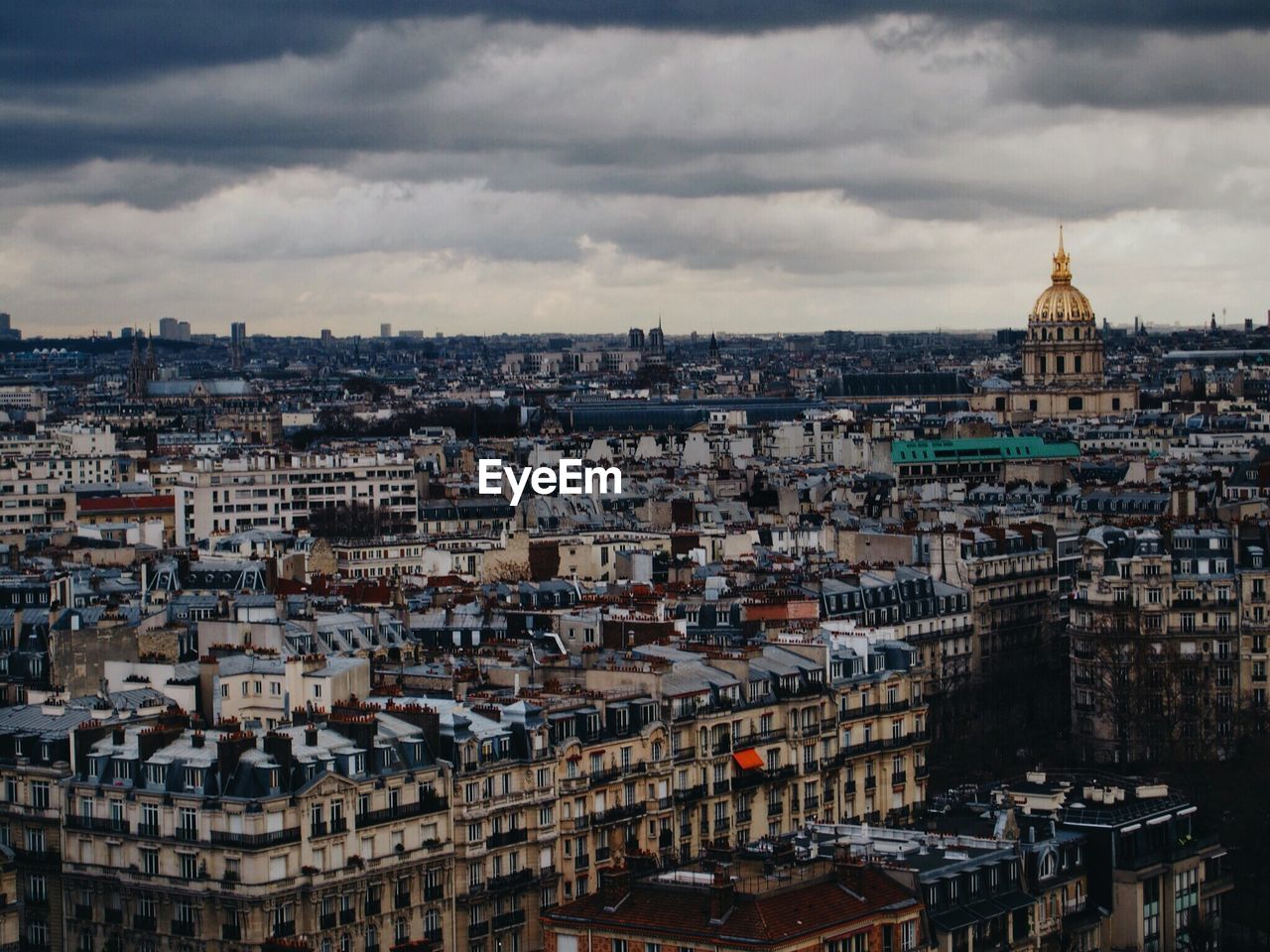 Cityscape against cloudy sky