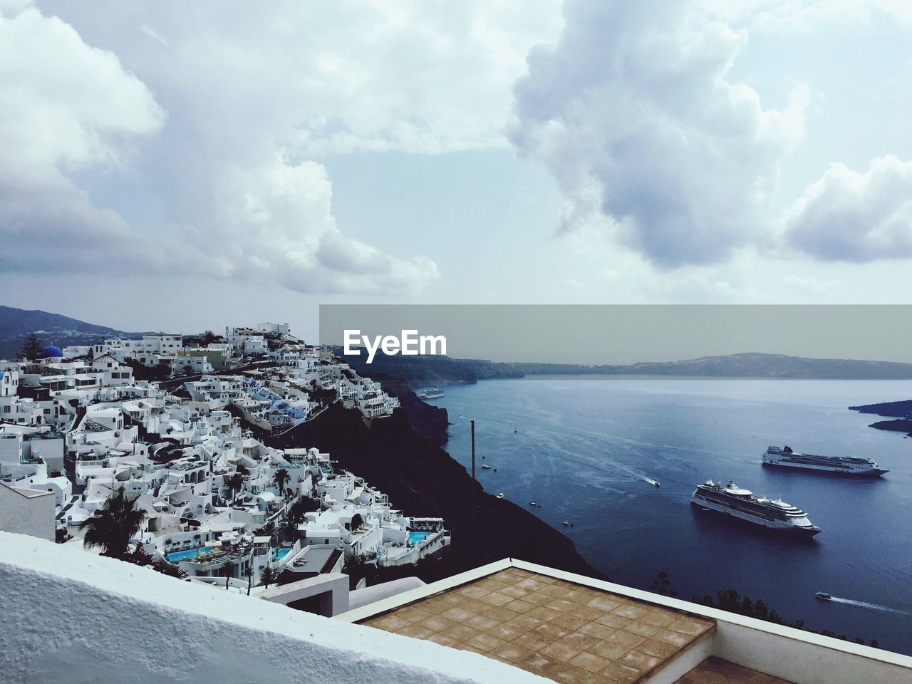 High angle view of townscape by sea against sky