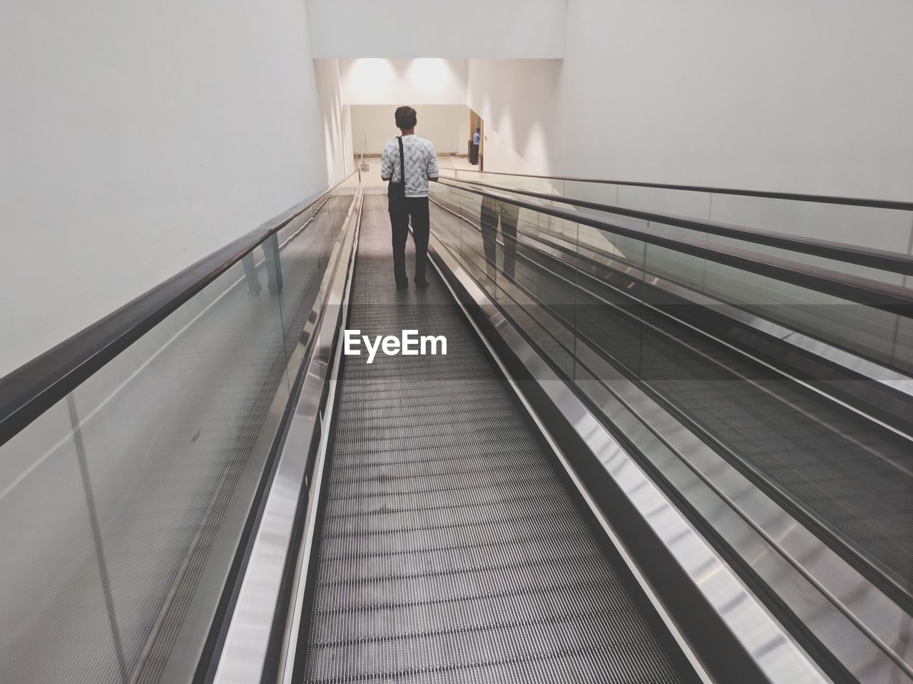 Rear view of man walking on steps