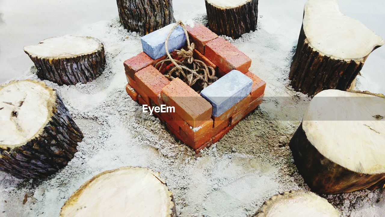 High angle view of campfire and tree stump outdoors