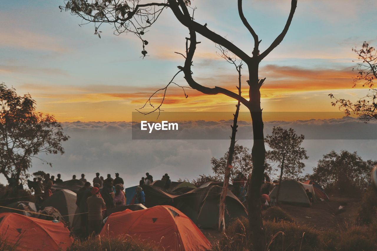 SILHOUETTE OF PEOPLE ON LANDSCAPE AGAINST SKY