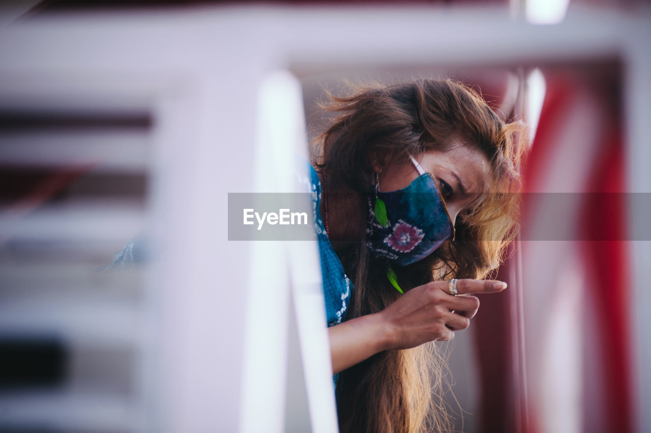 Low angle view of woman standing on balcony