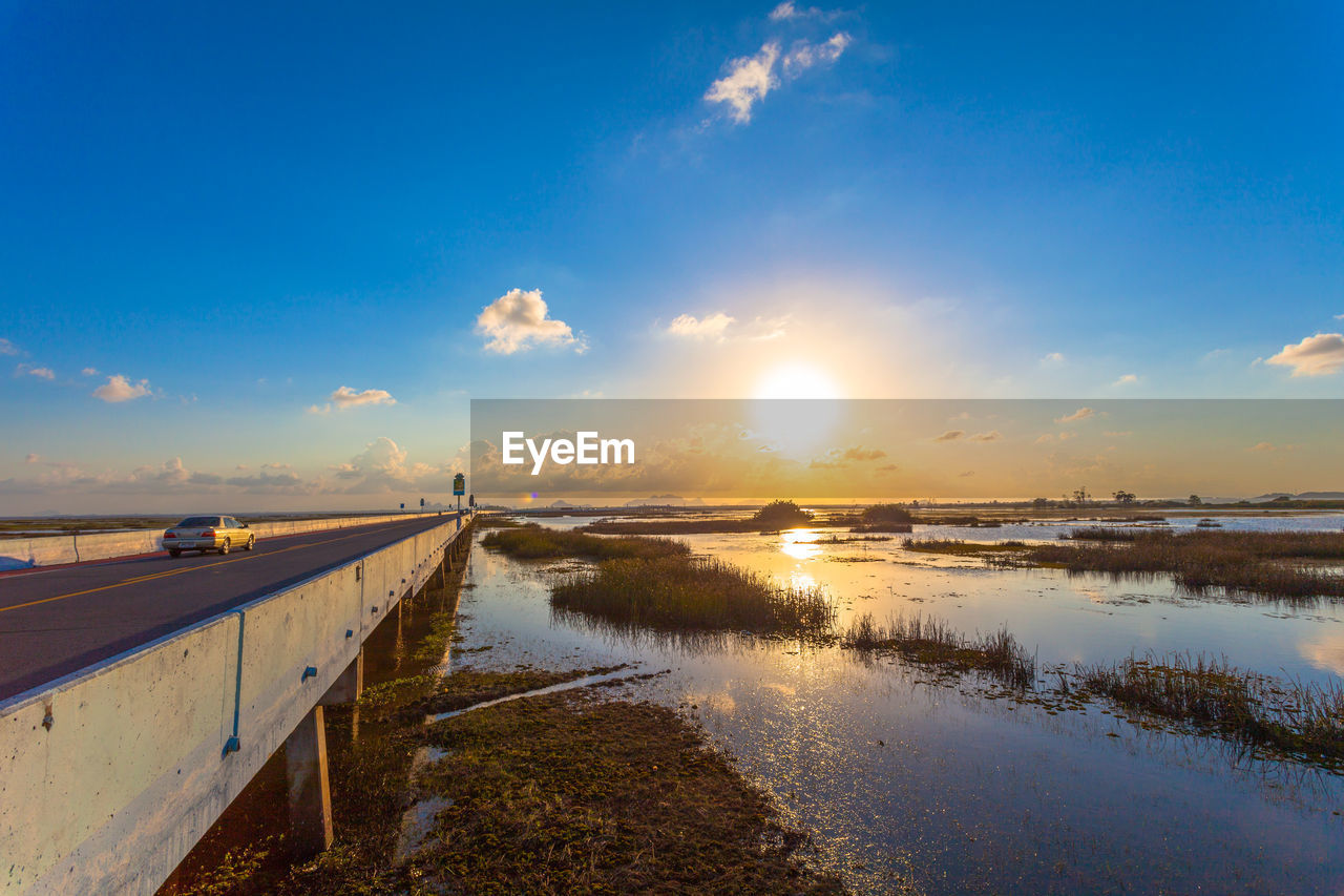 SCENIC VIEW OF SEA AGAINST BLUE SKY DURING SUNSET