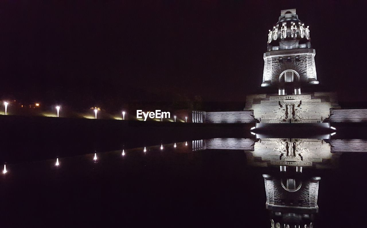 VIEW OF ILLUMINATED BUILDING AT NIGHT