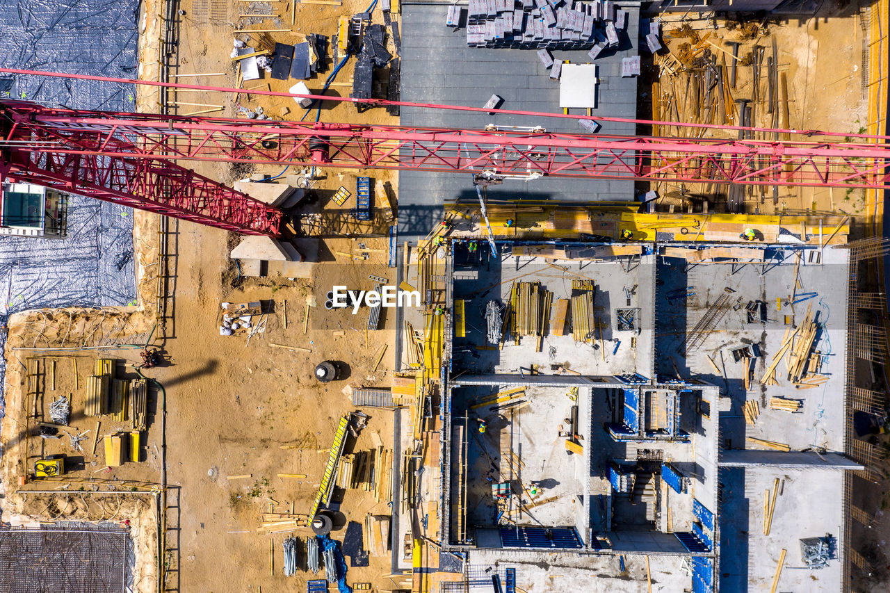 Worker is managing an elevated cherry picker at building site. aeria view