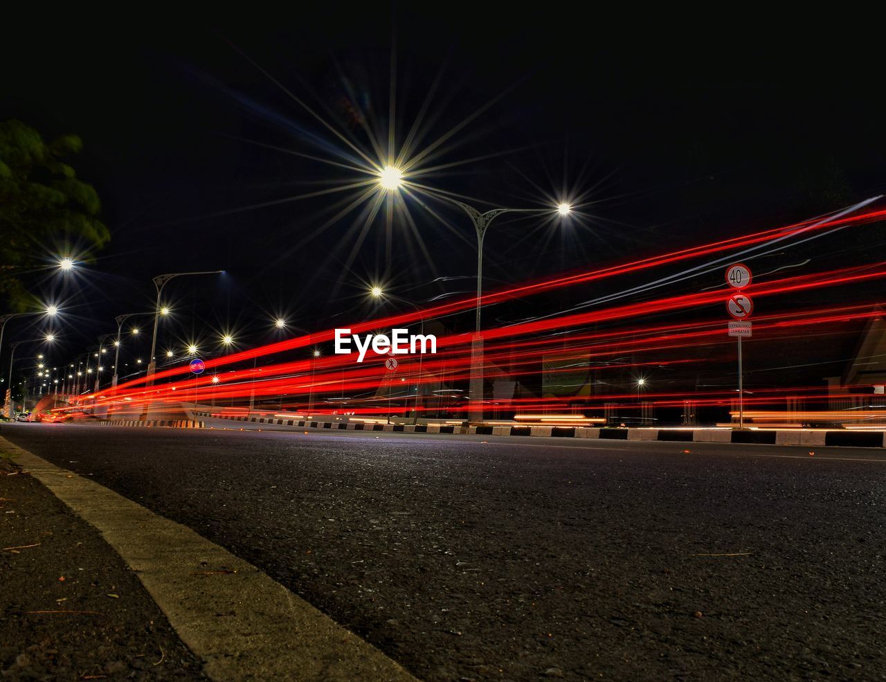 Light trails on road in city at night