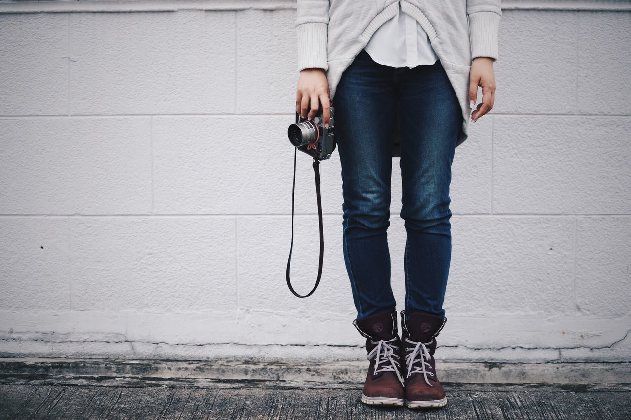 FULL LENGTH OF A YOUNG WOMAN STANDING ON GROUND