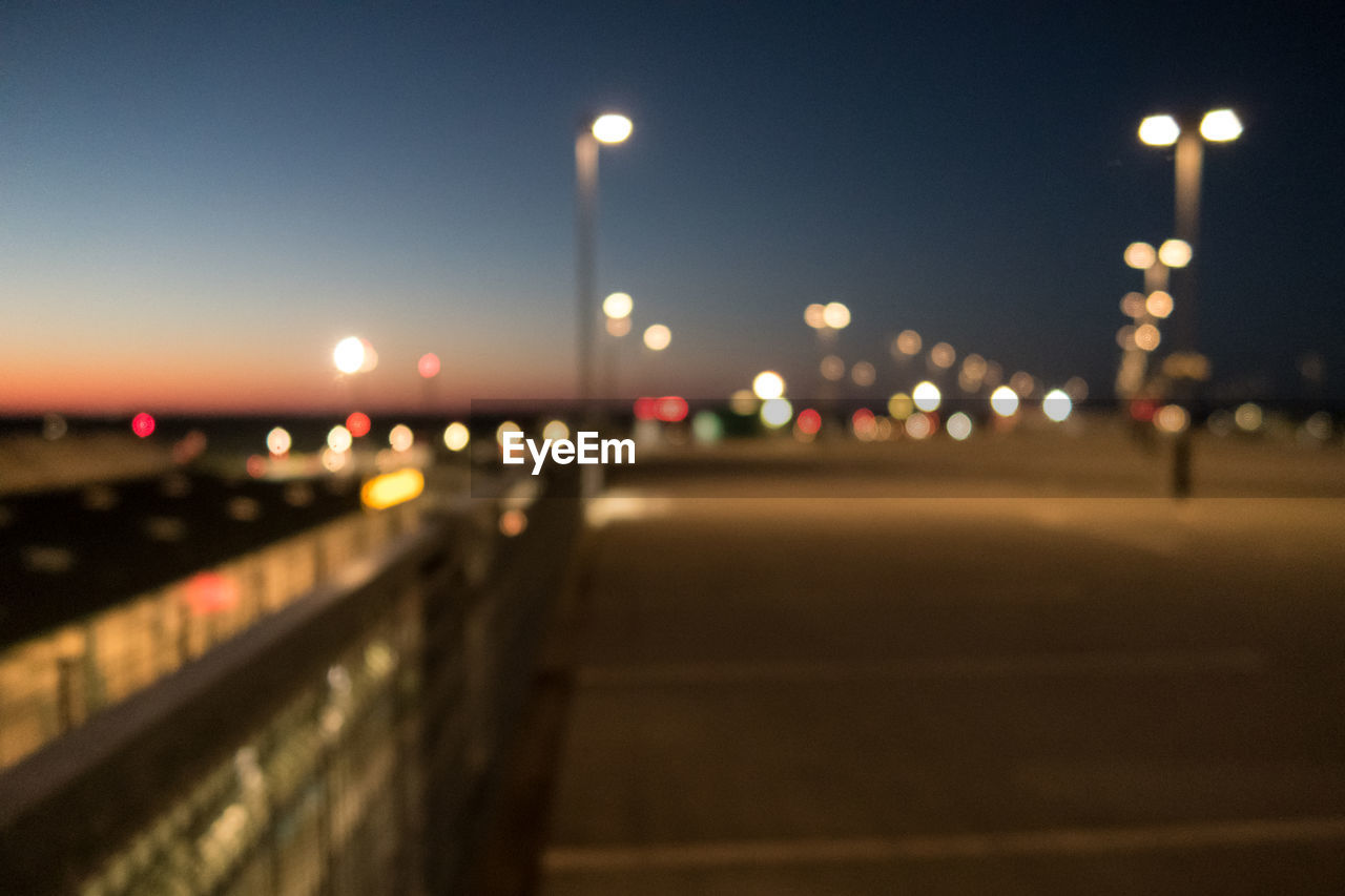 DEFOCUSED IMAGE OF ILLUMINATED STREET LIGHTS