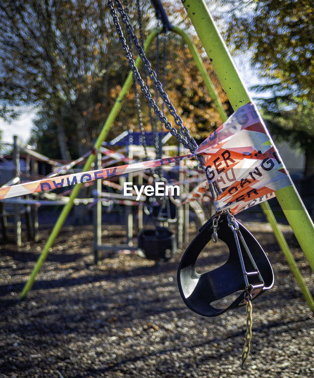 Close-up of swing hanging on field during the lockdown