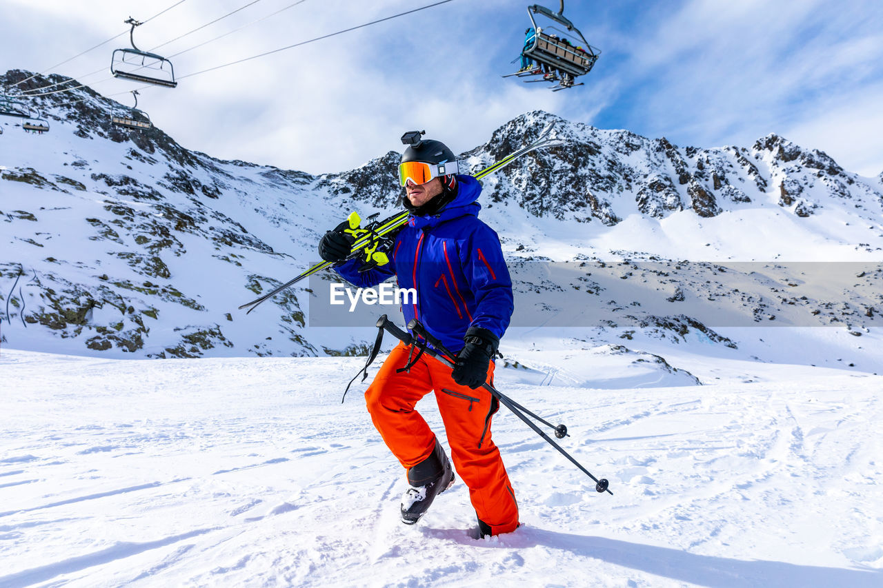 Man walking on snow covered land