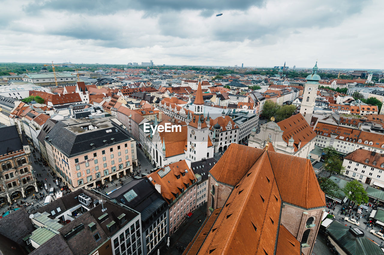 High angle shot of townscape against clouds