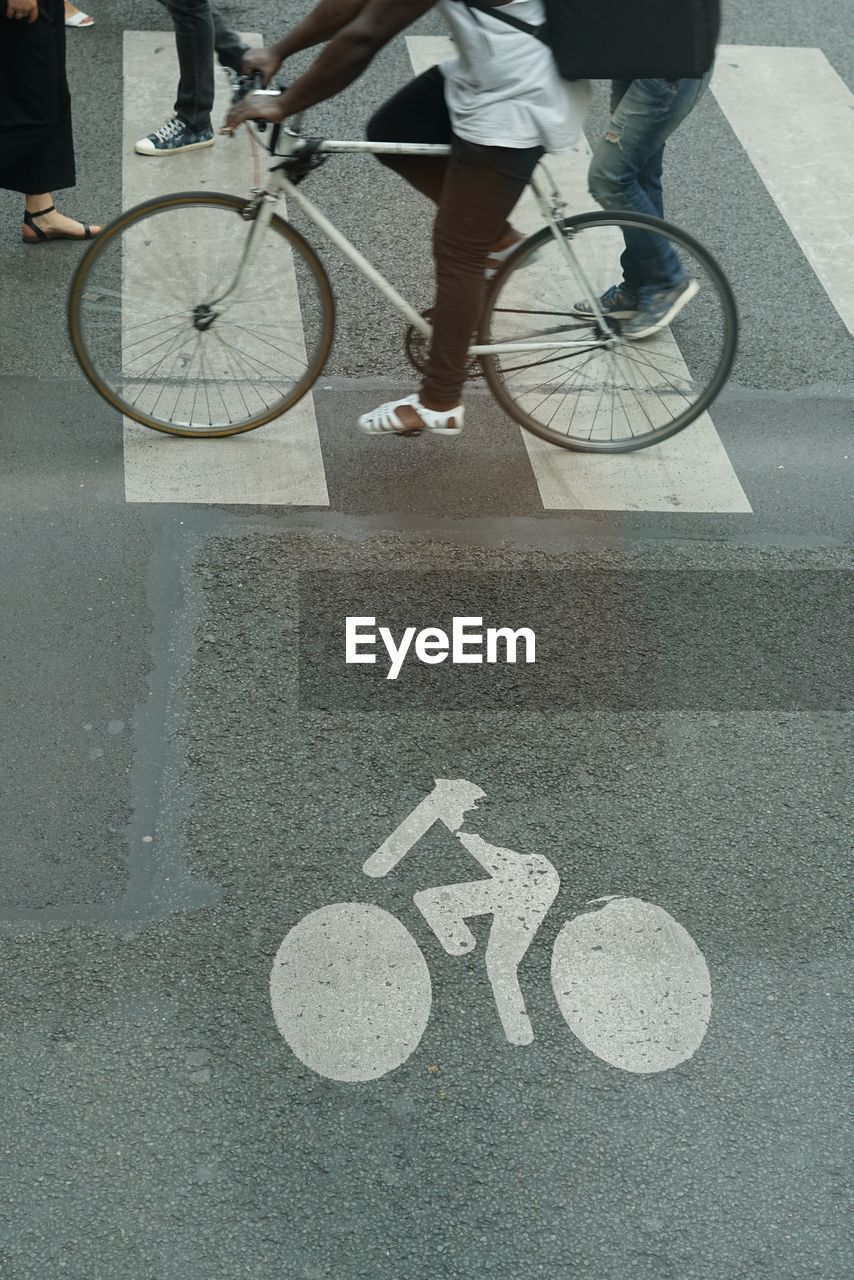 Low section of people crossing road on zebra crossing