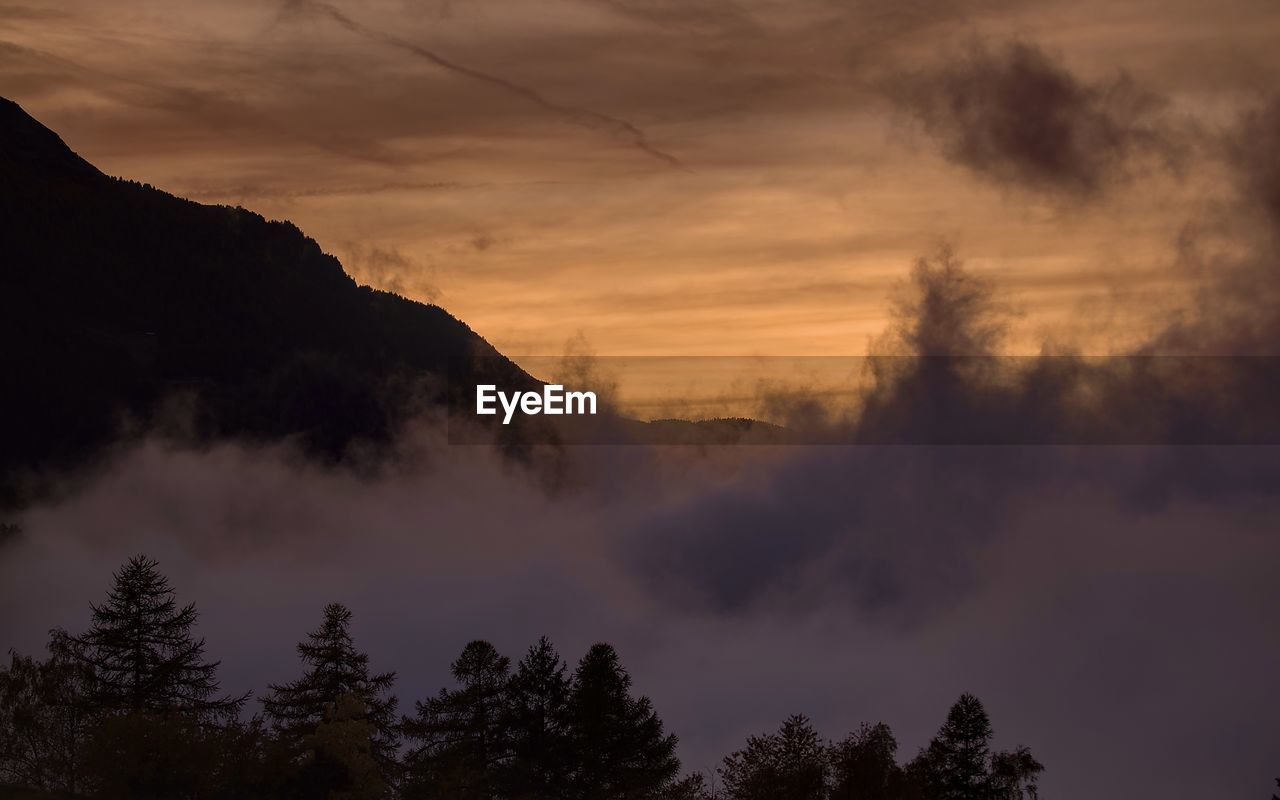 Scenic view of mountains against sky during sunset