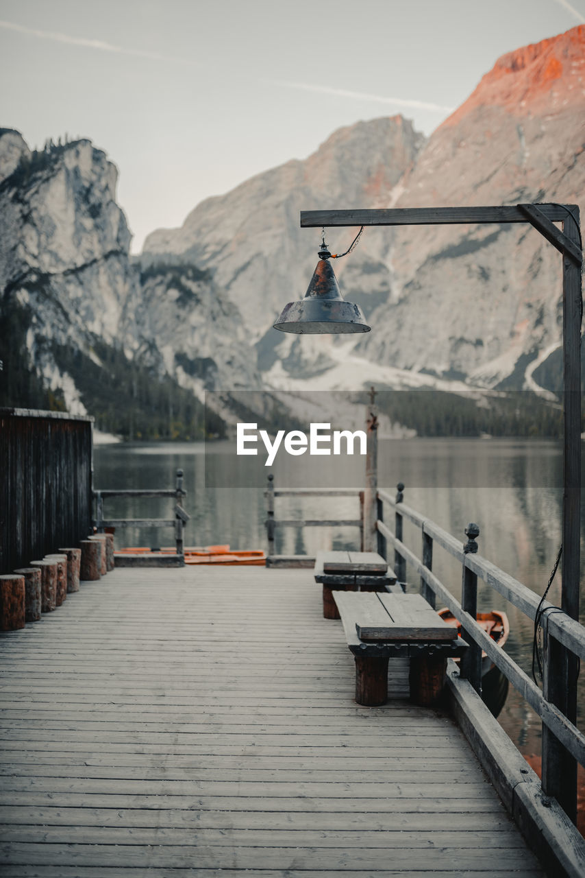 Pier in lake against snowcapped mountains