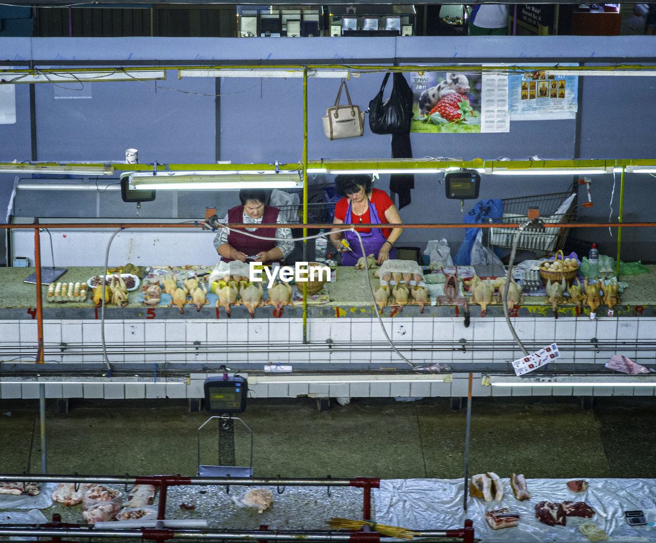 GROUP OF PEOPLE WORKING AT GLASS WINDOW