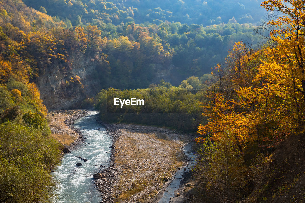 Autumn in the mountains and a mountain river in the gorge. 