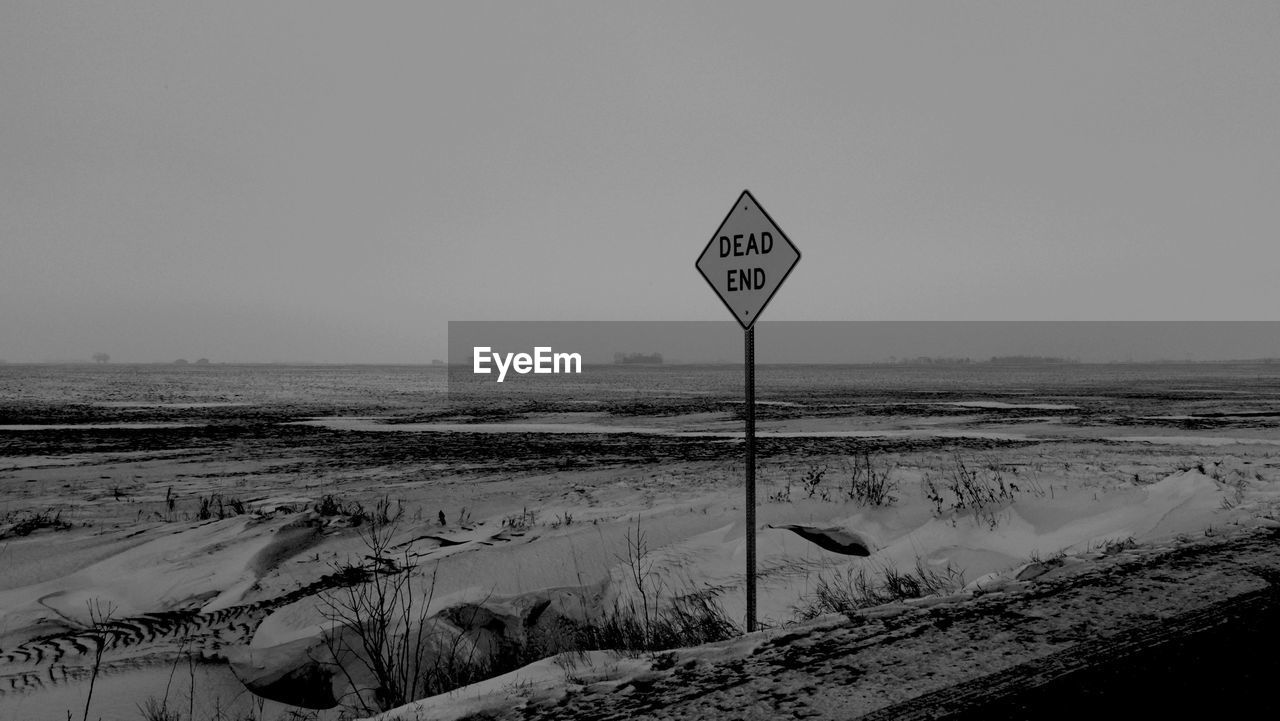 Dead end sign post on landscape