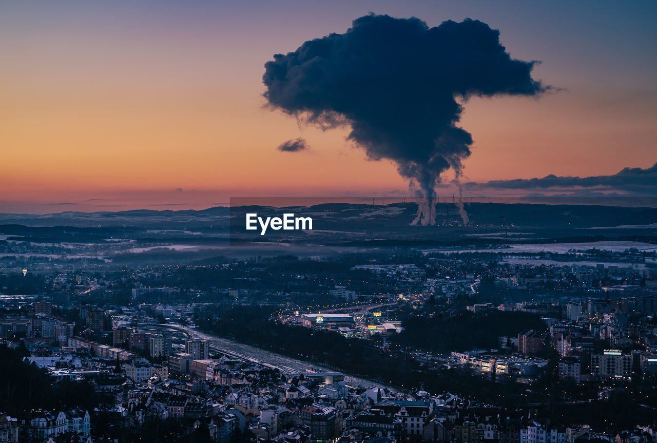 Aerial view of cityscape against sky during sunset