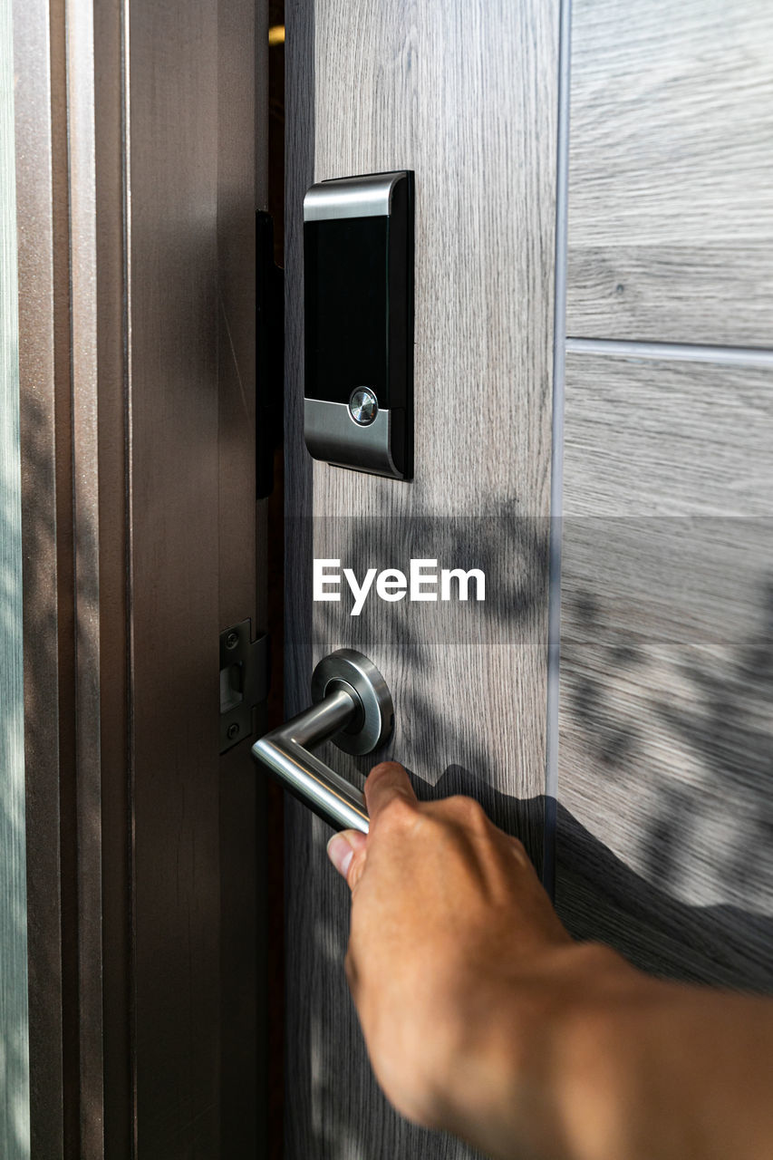 cropped hand of man repairing door handle