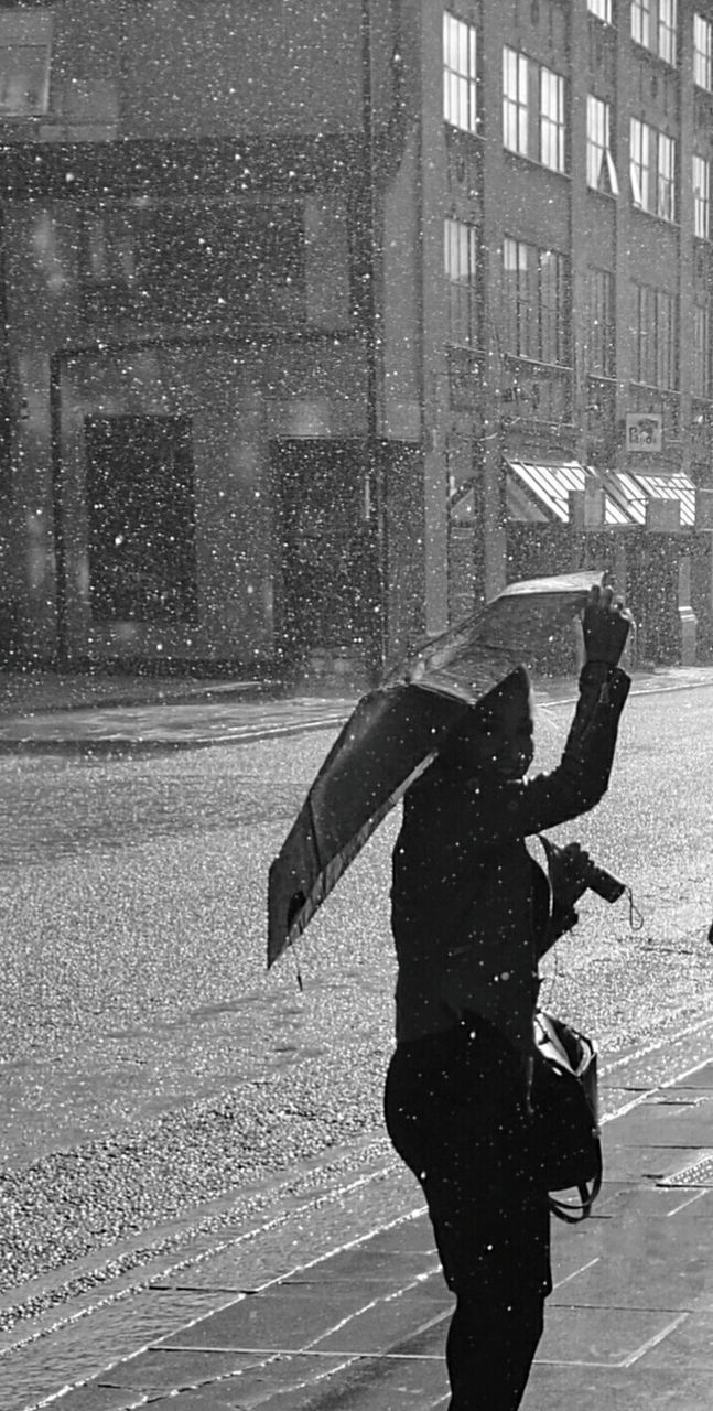 WOMAN WITH UMBRELLA ON STREET