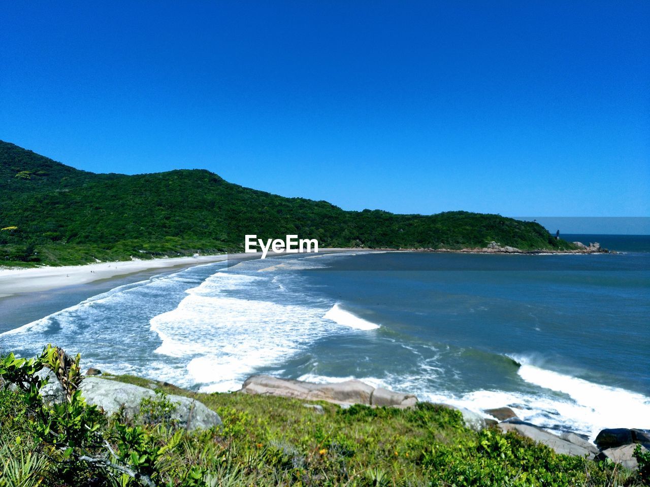 Scenic view of sea against clear blue sky