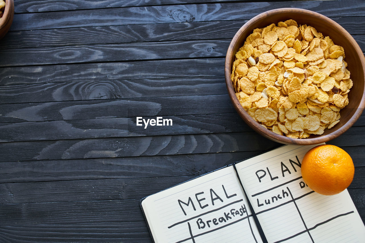 HIGH ANGLE VIEW OF BREAKFAST ON TABLE AGAINST BLACK BACKGROUND