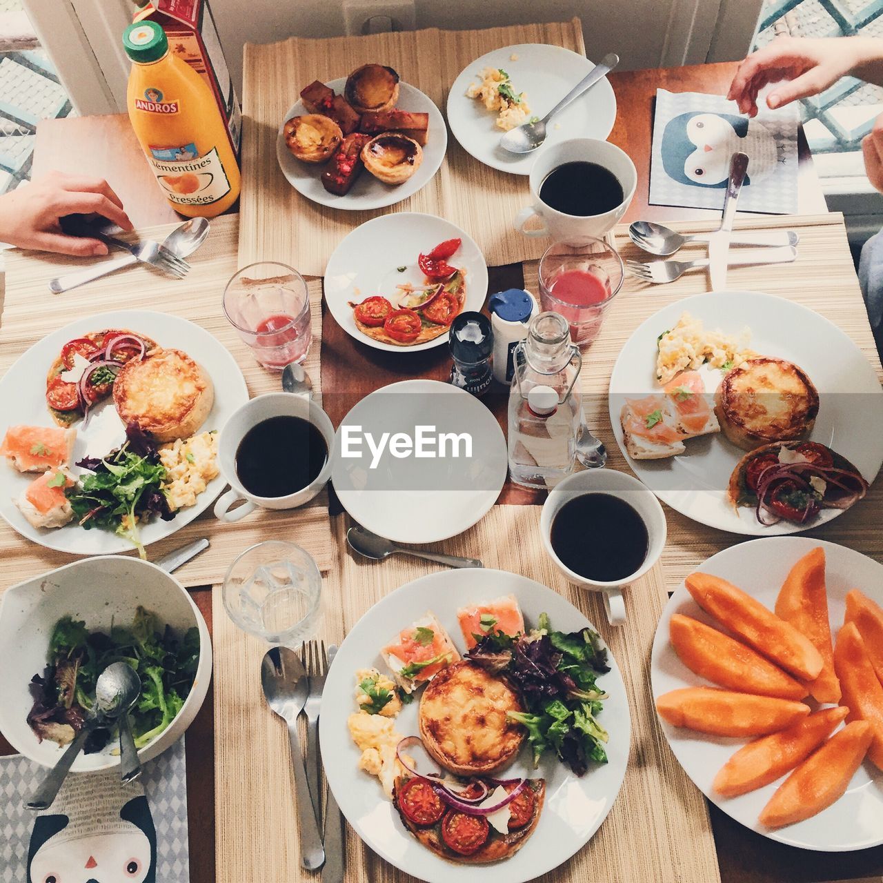 Cropped friends having various food on table