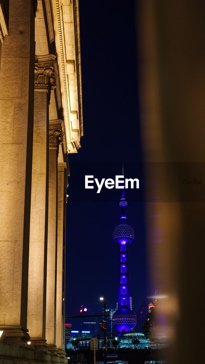 Low angle view of illuminated buildings against sky at night