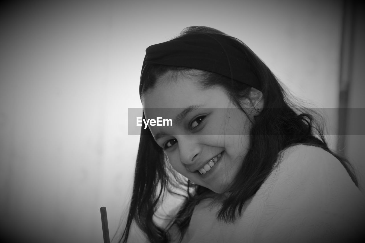 PORTRAIT OF WOMAN SMILING AT HOME