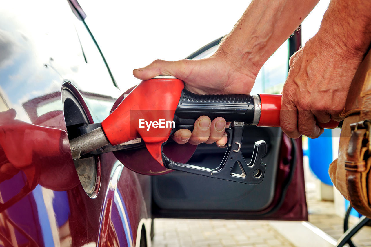 Cropped hand of man repairing car