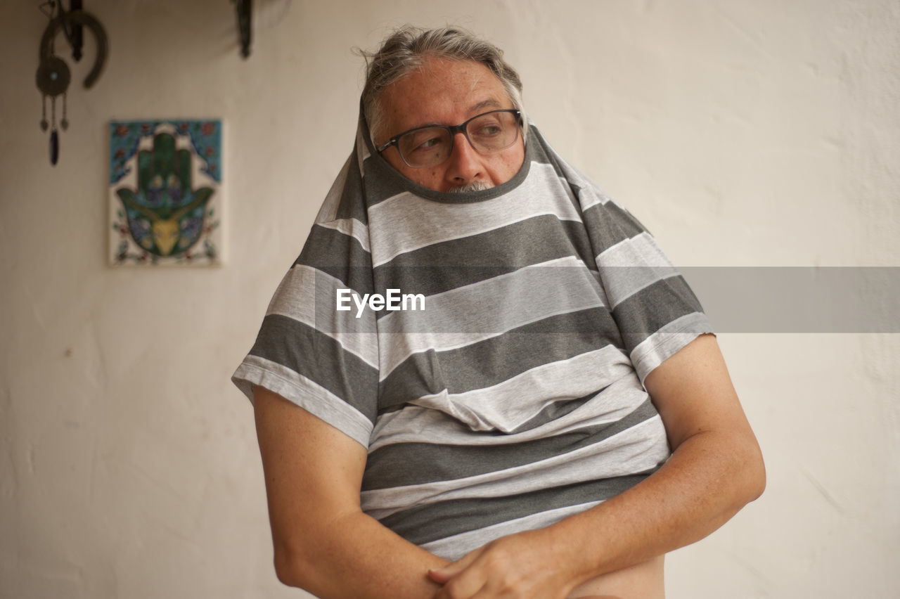 Senior man wearing t-shirt at home