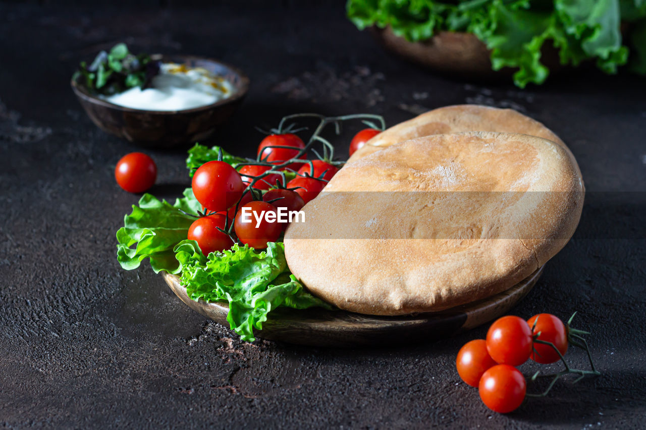 Traditional middle eastern lebanese cream cheese dip with olive oil, spices and herbs with pita.