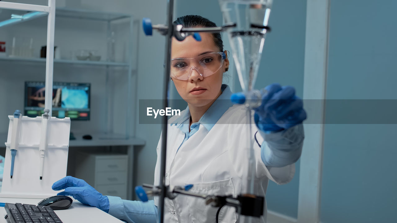 Female scientist experimenting in laboratory