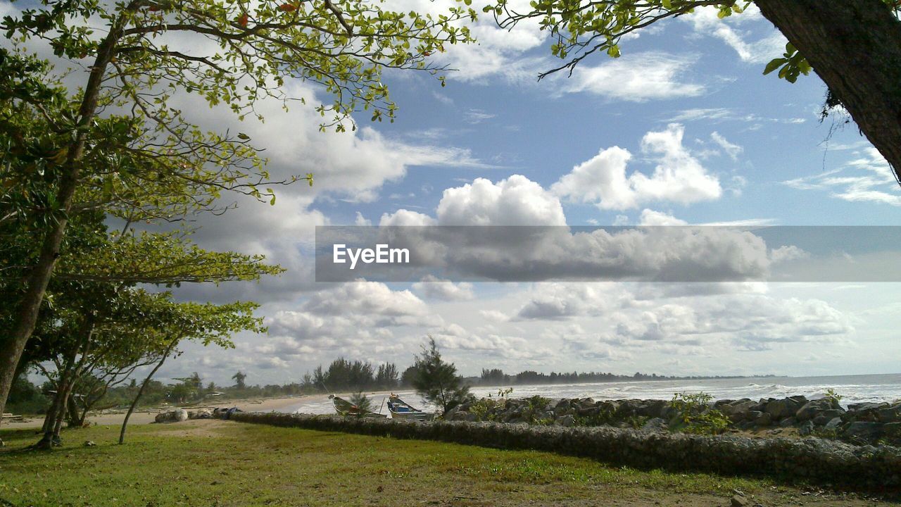 View of calm blue sea against clouds