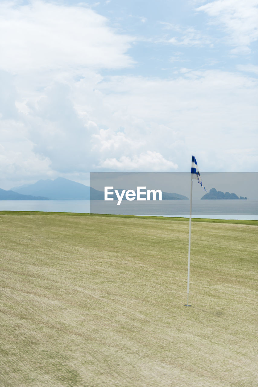 Scenic view of golf course against sky