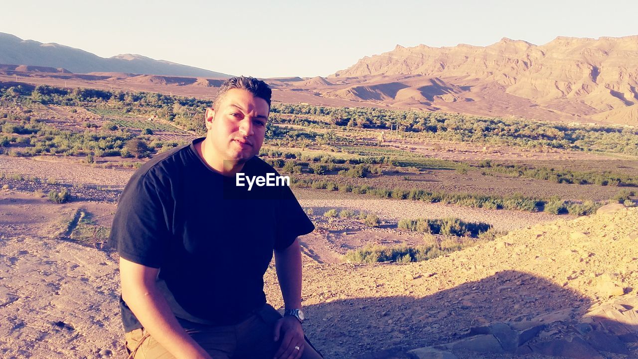 FULL LENGTH OF MAN STANDING ON DESERT AGAINST SKY