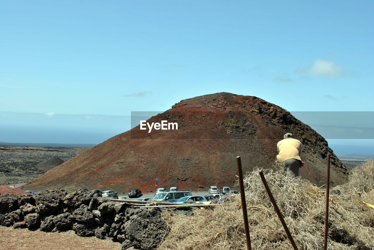ROCK ON BEACH AGAINST SKY