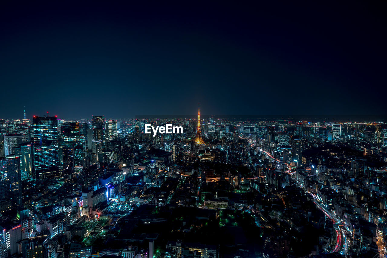 Aerial view of illuminated cityscape against clear sky