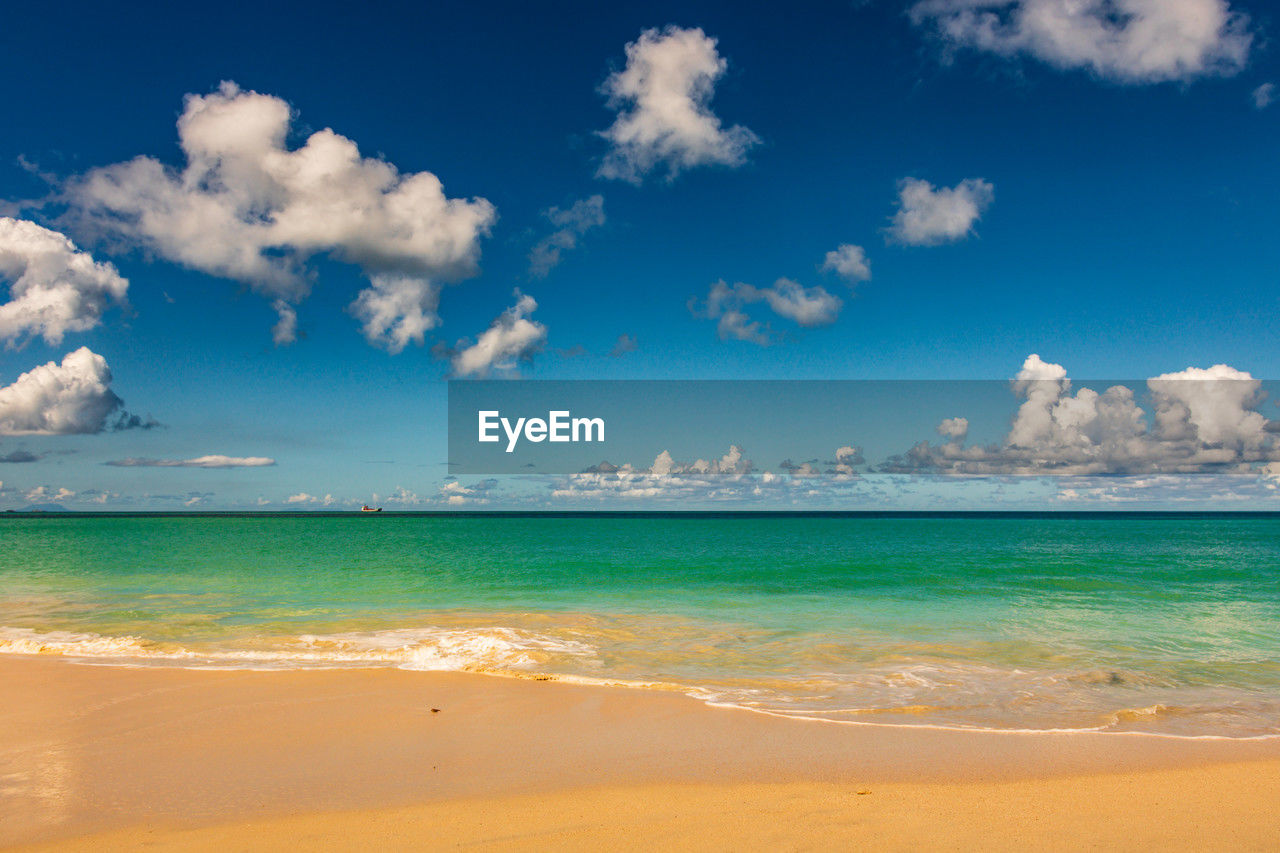 sea, water, land, sky, beach, horizon, cloud, scenics - nature, body of water, beauty in nature, nature, travel, travel destinations, sand, environment, tropical climate, blue, holiday, trip, vacation, ocean, shore, wave, tranquility, tourism, landscape, summer, wind wave, horizon over water, turquoise colored, water's edge, outdoors, tranquil scene, motion, coastline, idyllic, island, no people, seascape, sun, coast, lagoon, day, sunlight, sunny, sports, urban skyline, relaxation, water sports, cloudscape