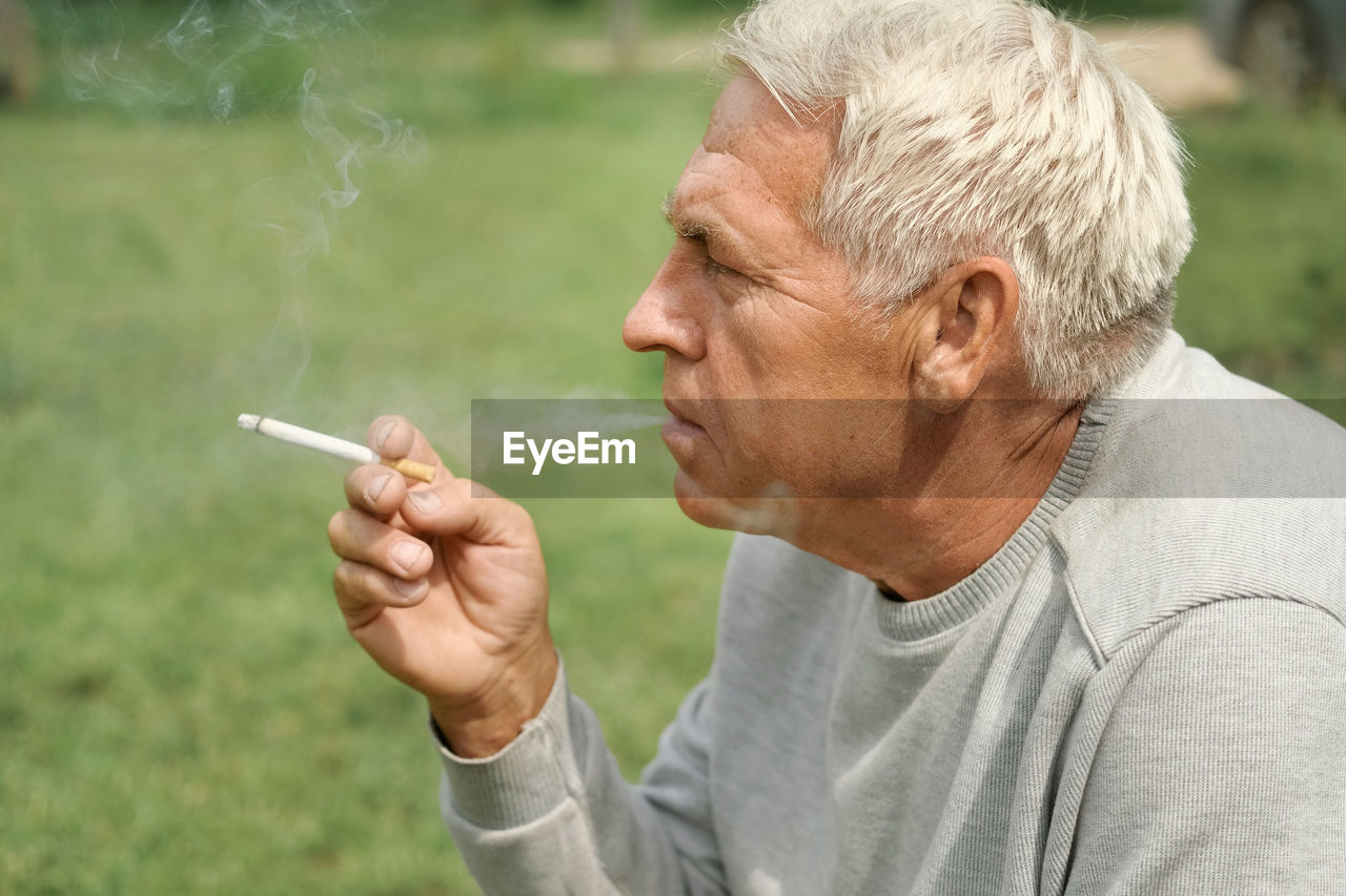 side view of man smoking cigarette