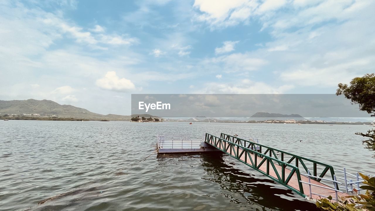 water, sky, cloud, shore, nature, sea, scenics - nature, beauty in nature, tranquility, pier, body of water, tranquil scene, land, architecture, day, travel destinations, travel, transportation, no people, environment, outdoors, landscape, coast, tree, beach, trip, holiday, vacation, tourism, built structure, bay, mountain, wood, nautical vessel, idyllic, reservoir, plant, jetty, non-urban scene