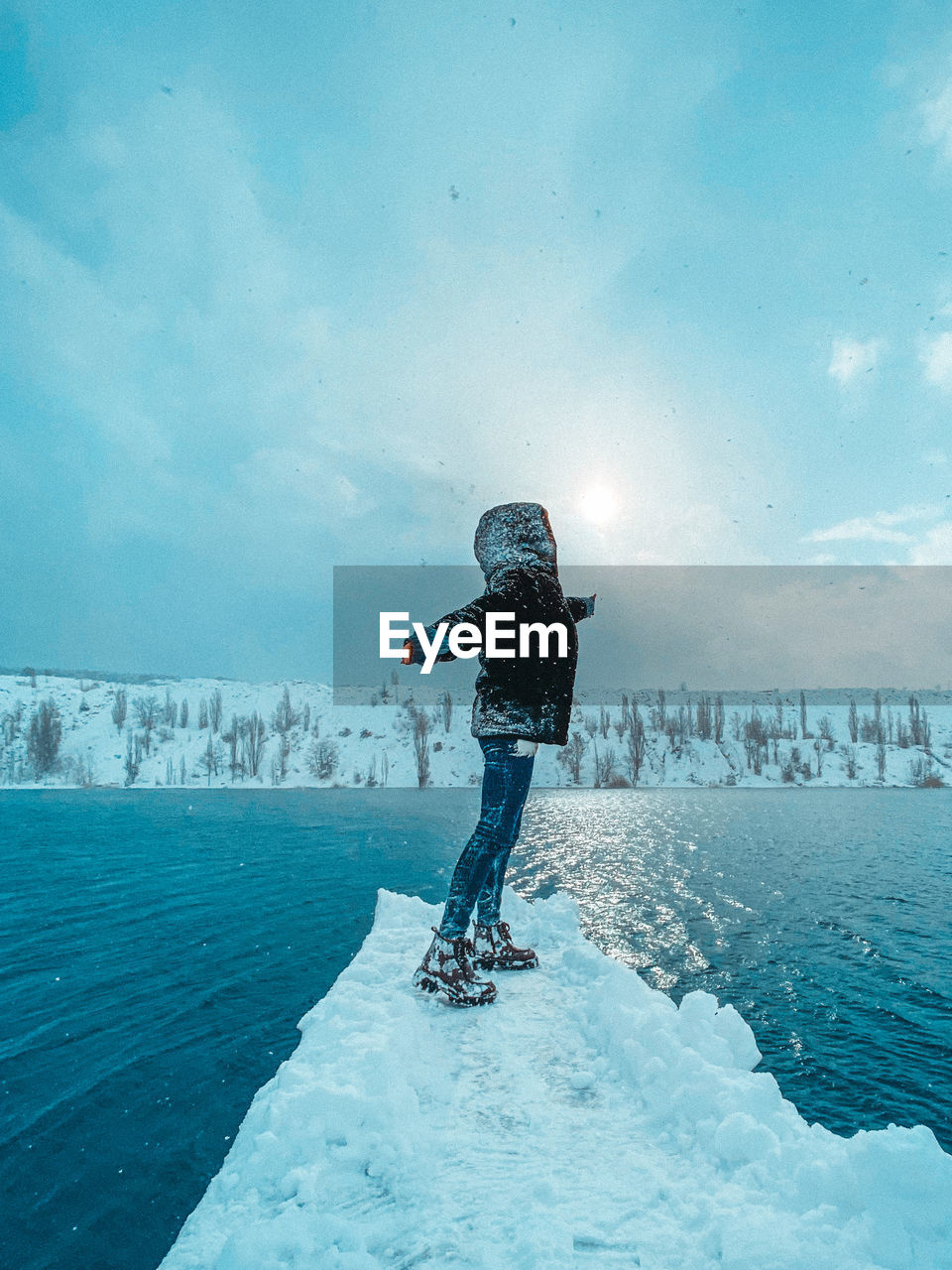 Man standing on snow against sky during winter