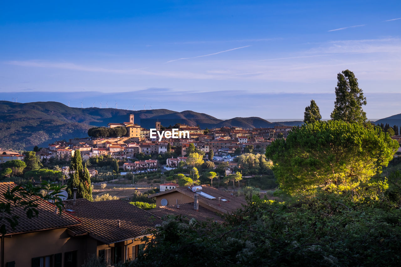 High angle view of houses in town against sky