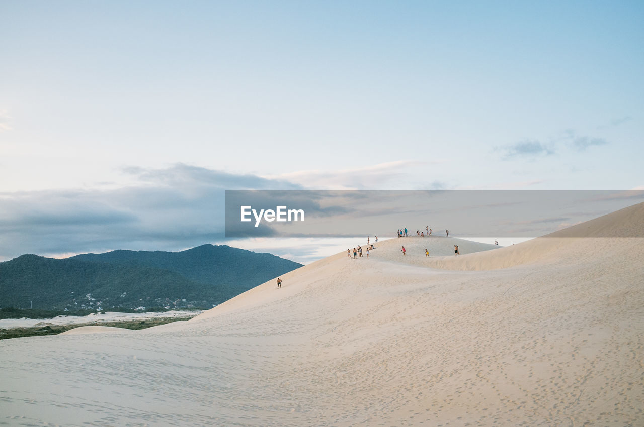 Scenic view of sand dune against sky