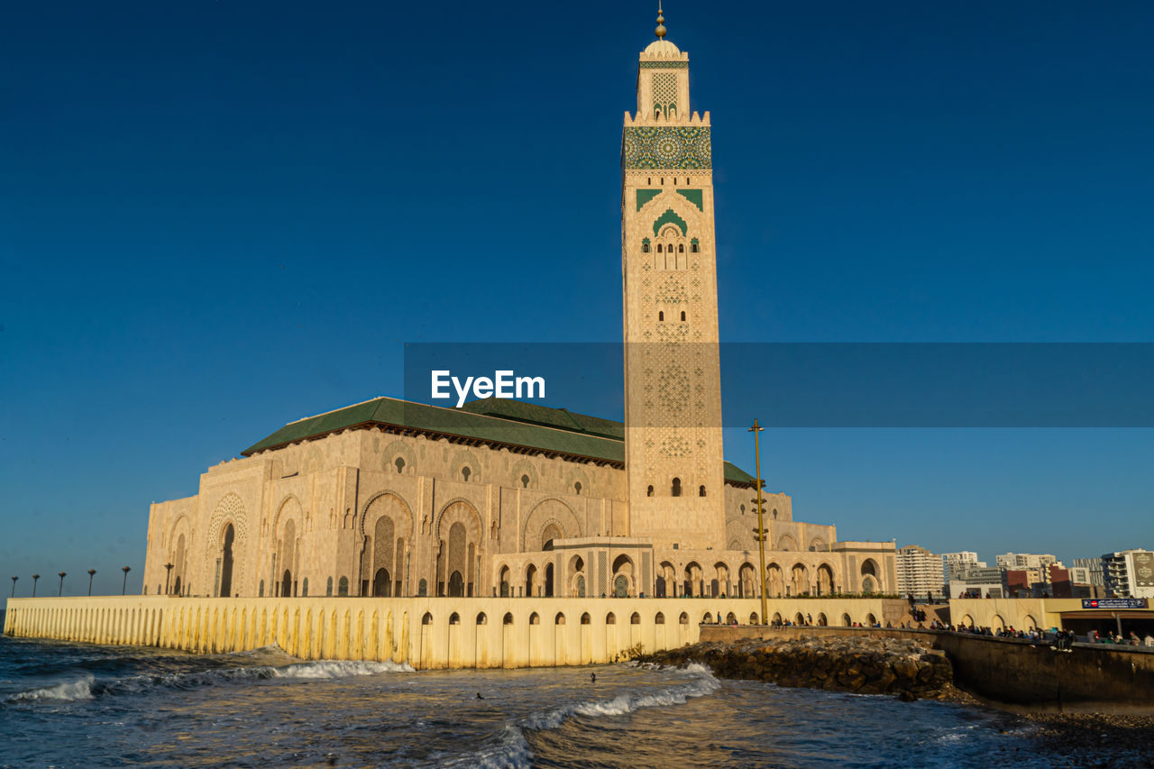 View of hassan ii mosque against blue sky in casablanca, morocco.