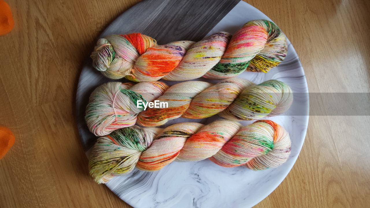 High angle view of yarn in plate on table