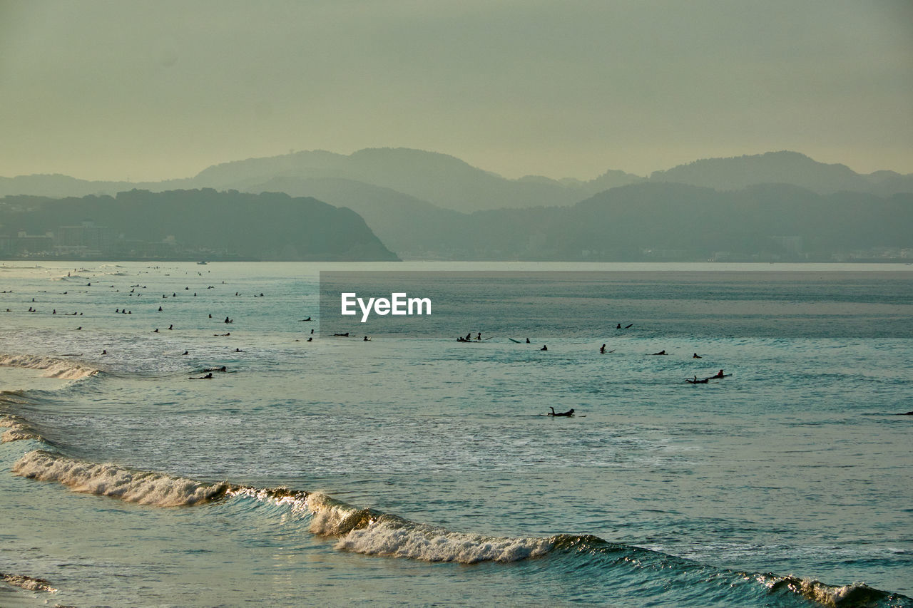 scenic view of sea and mountains against sky