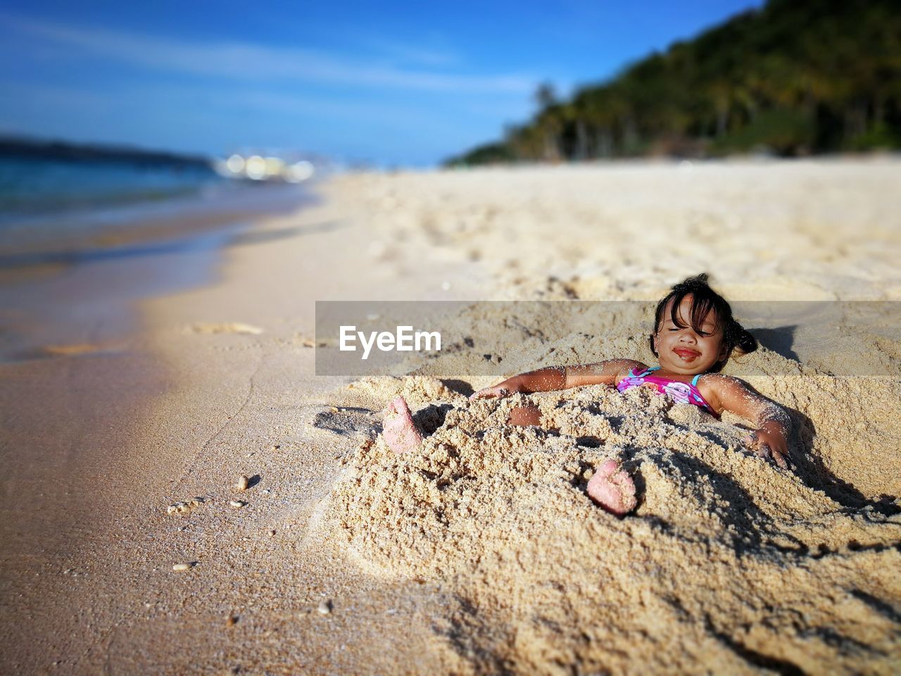 WOMAN LYING ON BEACH