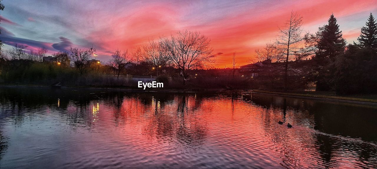 SCENIC VIEW OF LAKE AGAINST ORANGE SKY