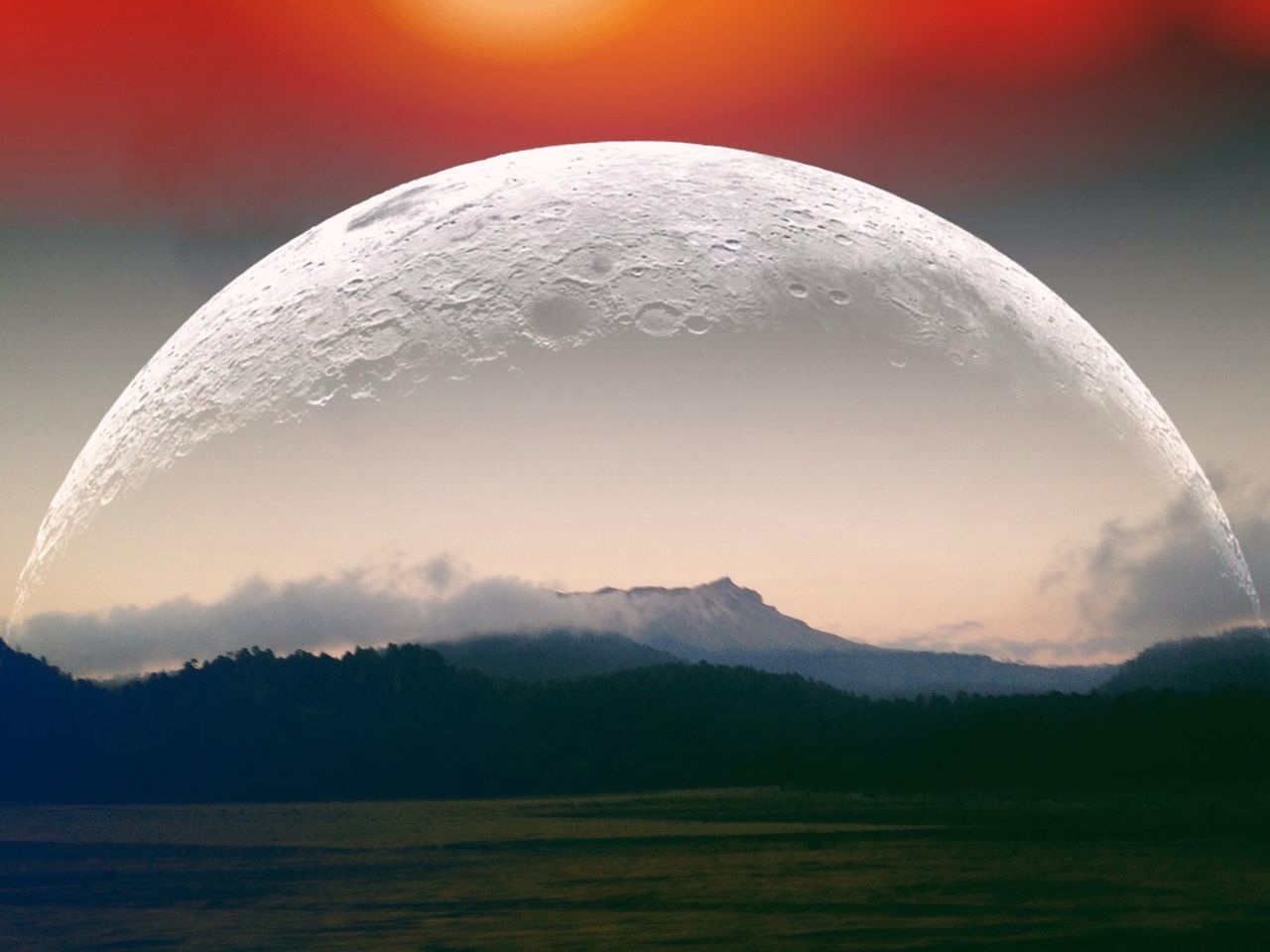 Moon against countryside landscape against mountain range